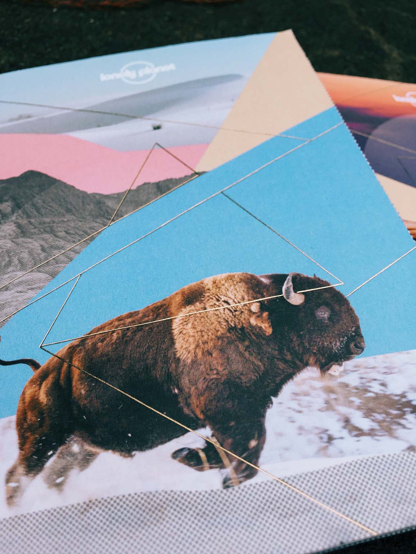 Close detail of Lonely Planet postcard print objects