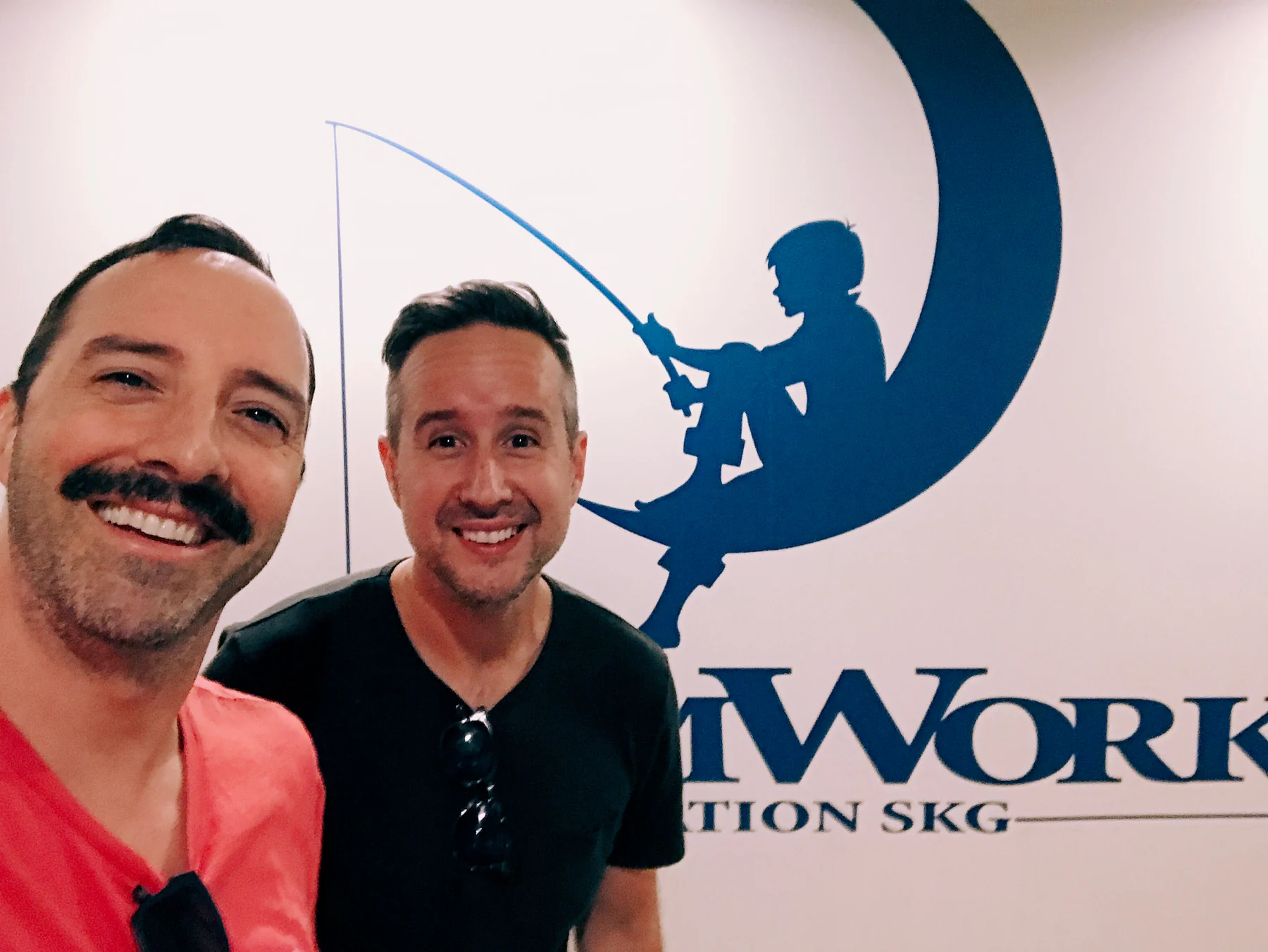 Victor Huckabee and Tony Hale in front of the DreamWorks Animation logo