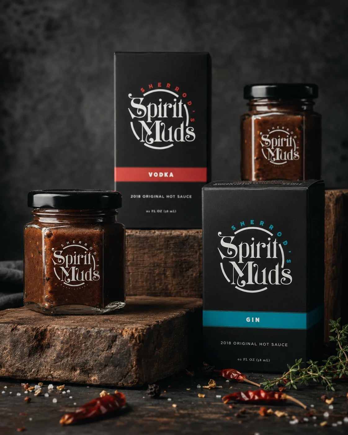 Spirit Muds hot sauce jar and packaging in a dark product scene