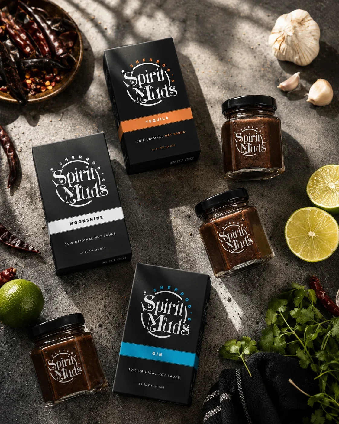 Spirit Muds hot sauces arranged with fresh ingredients
