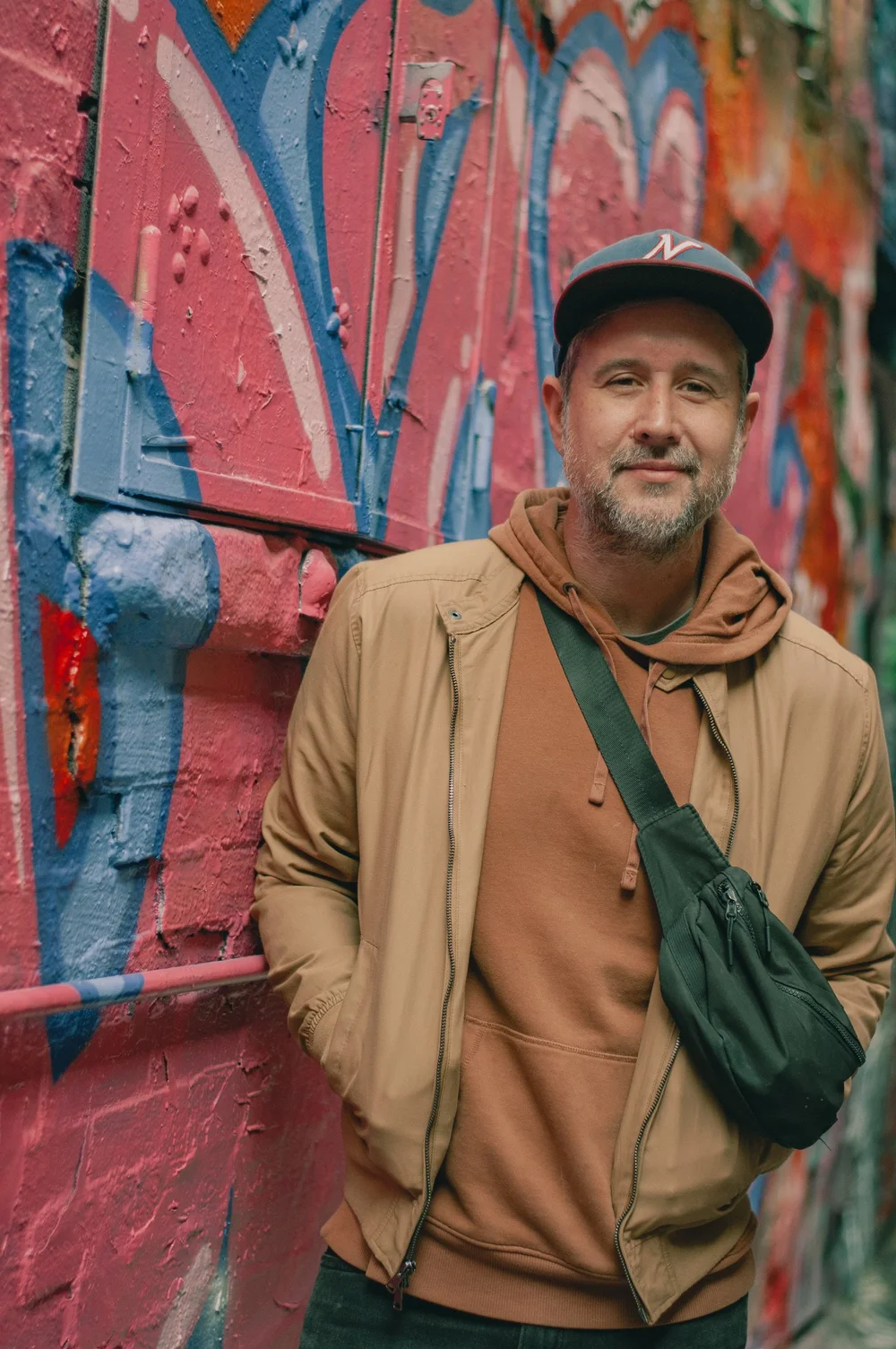 Portrait of Victor Huckabee in front of a colorful wall